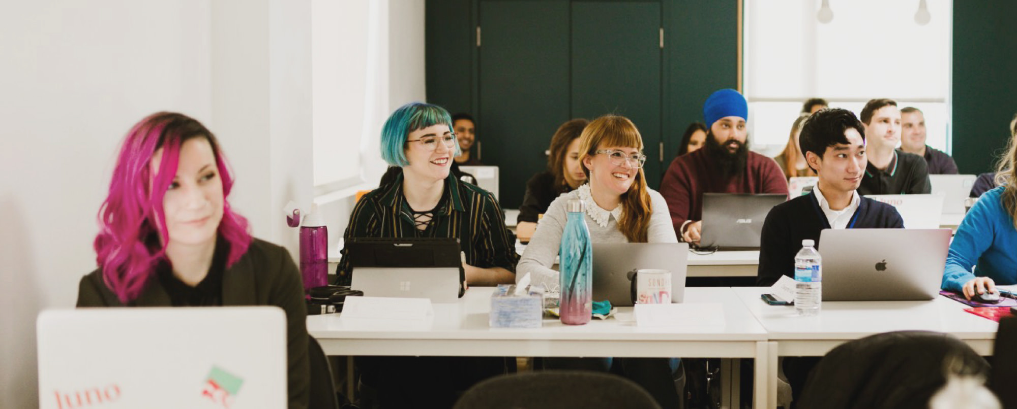 Group of young, diverse Juno students learning in a classroom at the Toronto campus